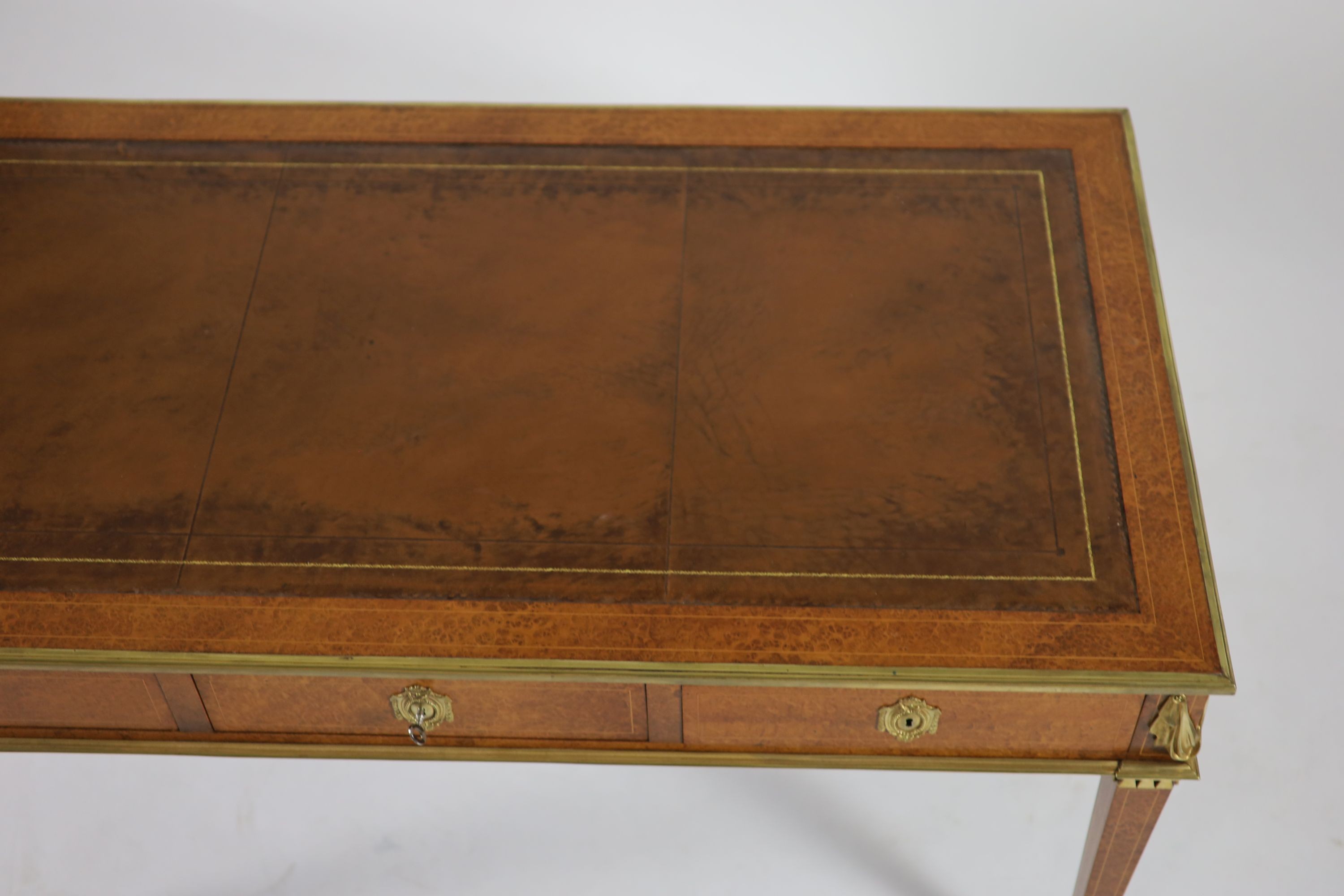 Laporte Barmen. A Louis XVI style ormolu mounted burr wood bureau plat, W.142cm D.76cm H.77cm